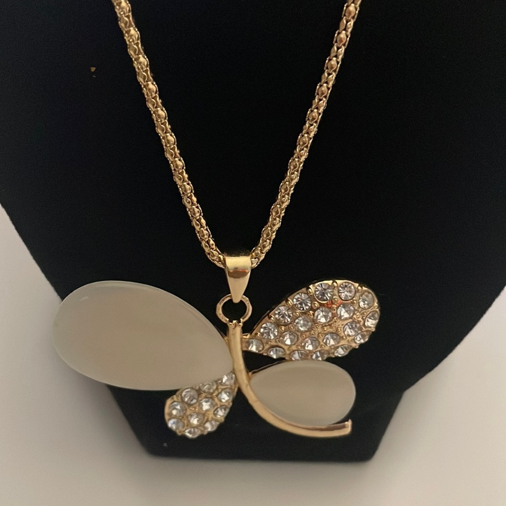 Long gold necklace with bling pendant